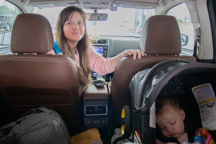After an Amazon shift, Savannah Dobson stops for gas with her 7-month-old baby, Shiloh. Dobson said she has submitted over 300 applications for jobs that will fit her schedule while taking care of Shiloh.