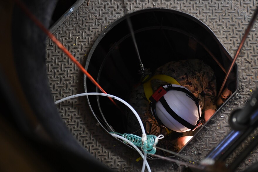 AIEA, Hawaii (March 7, 2022) Lt. Travis Christensen, assigned to Naval Facilities Engineering Systems Command Washington, descends into Red Hill Well. The Interagency Drinking Water System Team is a joint initiative where the U.S. Navy is working closely with the Hawaii Department of Health, U.S. Environmental Protection Agency and the U.S. Army to restore safe drinking water to Joint Base Pearl Harbor-Hickam housing communities. For detailed information, go to: www.navy.mil/jointbasewater. (U.S. Navy Photo by Mass Communication Specialist 2nd Class Chelsea D. Meiller)