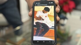 A relative shows a photograph of Williams Javier Toro Enamorado with his newborn son. Enamorado was one of hundreds of people detained by federal immigration officers during "Operation Charlotte's Web,"