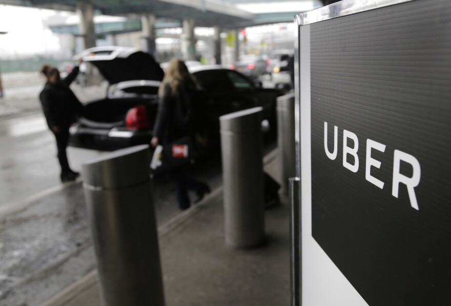 A pick-up point for the Uber car service at LaGuardia Airport in New York is shown in 2017. The Justice Department has sued Uber, accusing the company of illegally charging wait time fees to people with disabilities.