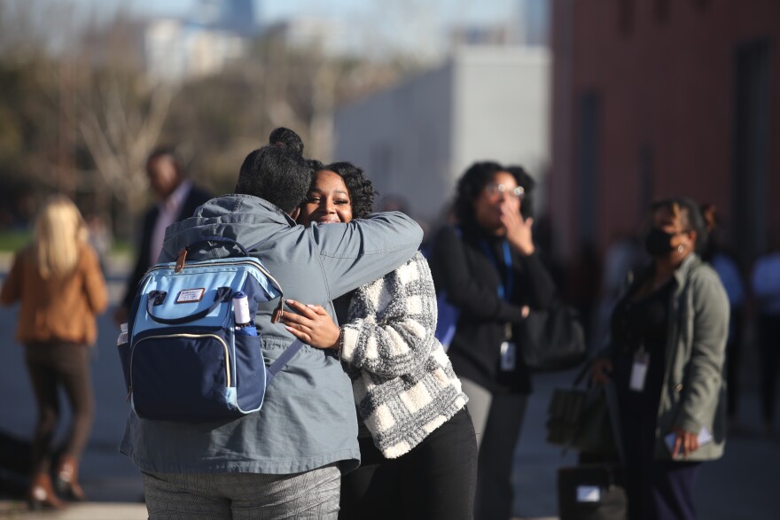 Chartaveoua Graggs hugs a colleague during a active shooter situation Thursday, Feb. 9, 2023, at the Dallas County Health and Human Services building.