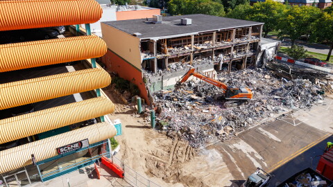 Demolition crews tear down the former Spartan Bookstore in East Lansing, Mich., on Sept. 14, 2026. A new apartment high-rise will be built on the site.