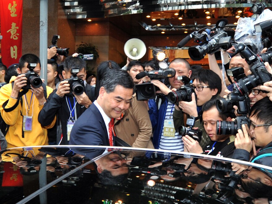 The other top candidate for chief executive, Leung Chun-ying (center, shown here Feb. 23), is also under scrutiny, for an alleged conflict of interest while judging a design contest for an arts complex — in which he allegedly voted for a company linked to his own.