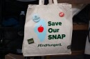 A volunteer holds a “Save our SNAP” bag at a rally on April 14 in Springfield. An estimated 150,000 Illinoisians could lose their SNAP benefits beginning May 1 due to changes from the One Big Beautiful Bill Act.