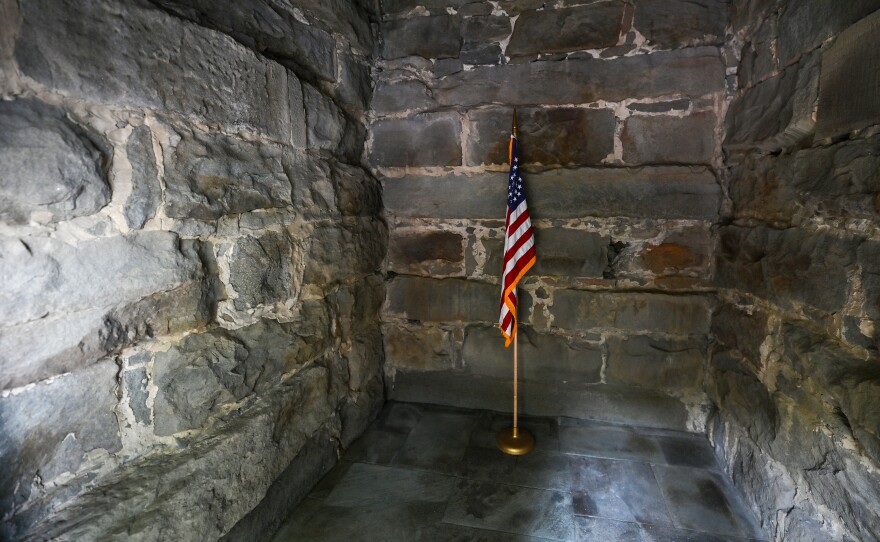 A single American Flag stands inside the Wyoming Monument.
