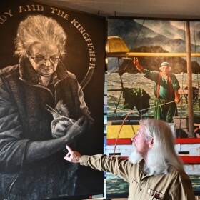Lawrie points to his portrait of bartender Rita Ledbetter.