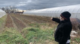 Claudia Rosales pointing to the field she worked on when she was an agricultural farmer.