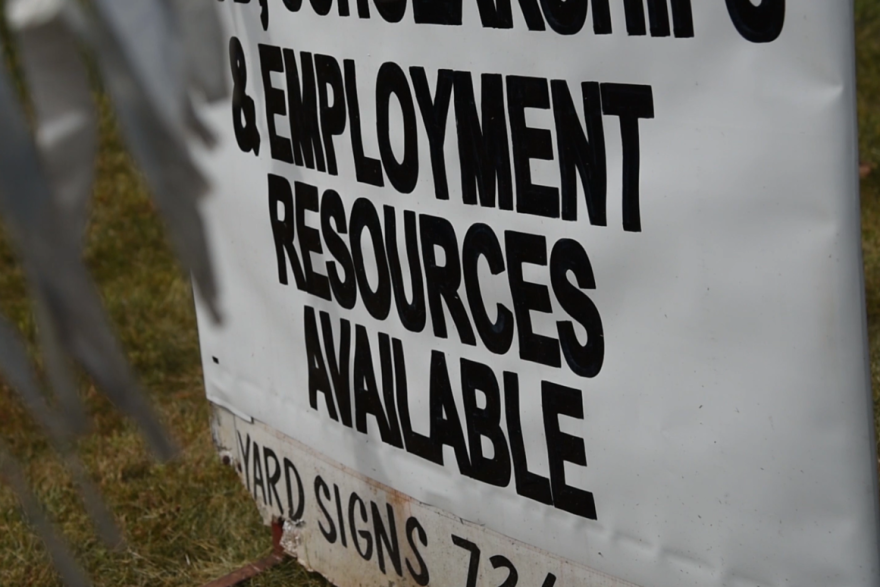A sign outside Nu Corinthian Baptist Church in Indianapolis advertises employment resources at a weekly food handout during the pandemic.