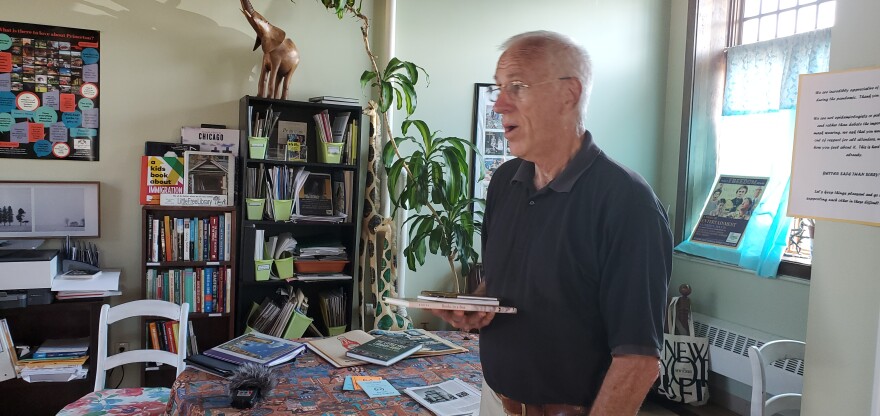 Rick Brooks talking to one of his partners inside his office at the Princeton Amtrak Station