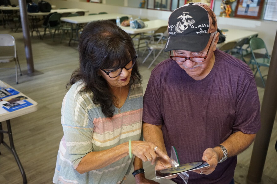 Lydia Anaya and Johnny Anaya look at photographs in the basement of Our Lady of Guadalupe in Flagstaff, Ariz. on March 2026.