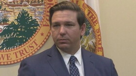 close up image of man in a gray suit looking to his left