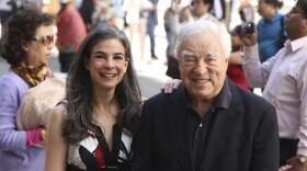 Arthur Frommer, 83, and his daughter, Pauline Frommer, 46, are shown posing among tourists in the Wall Street area in New York, May 20, 2012.