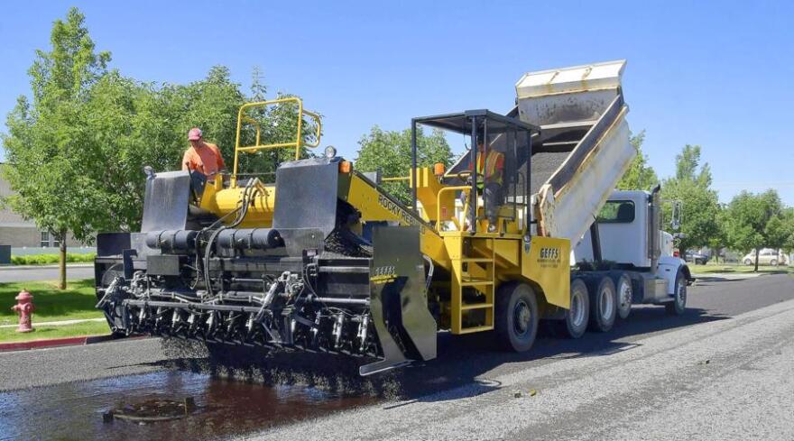 Logan City workers chip and seal 1600 North on Wednesday morning.