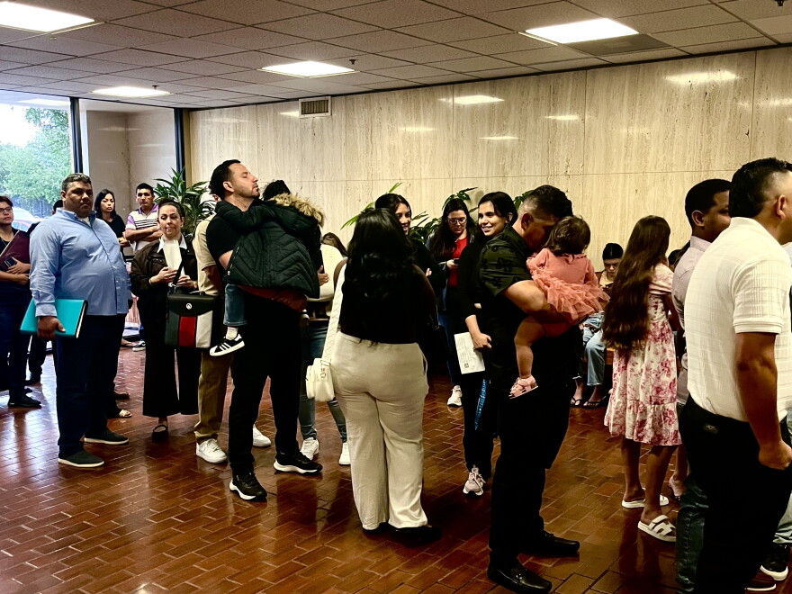 Families and their children wait in line for their cases to be heard on a Friday morning in mid-October at San Antonio Immigration Court.