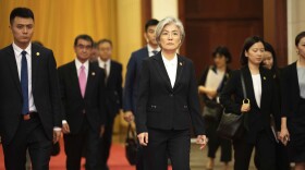 South Korea has announced it will withdraw from a 2016 military intelligence-sharing pact with Japan. Here, South Korean Foreign Minister Kang Kyung-wha, center, and Japanese Foreign Minister Taro Kono, trailing at left, walk in Beijing's Great Hall of the People on Thursday.
