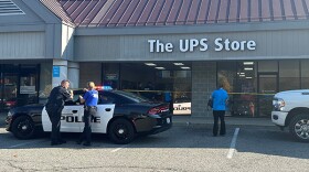 Police and store employees stand around The UPS Store located at 885 S College Mall Rd Friday, Nov. 4, 2022. Another car damaged the same store in April.