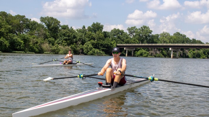 Elijah Gilmore (front) and Roman Sykora row their single sculls up the Brazos River in Waco, Texas during a practice session on June 3, 2026. The two teenagers are the first Waco Rowing Center athletes to qualify for the USRowing Youth National Championships.