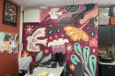 After their art classroom flooded, Riverside University High School art teacher Paige Bauske and her students painted this mural to bring color and new life back into the space. Many of the art materials were lost in the August 2025 floods.