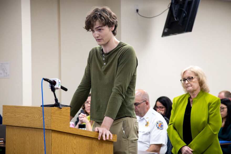 Skyler Carpenter speaks of his opposition to the Tuscana project during a public comment period at the April 2 DRC meeting, as Laura Betts (right) waits for her turn to echo a similar sentiment. “A species must be saved in many places if it is to be saved at all,” Carpenter said, referencing the bald eagles, sandhill cranes and other protected species that live in Shingle Creek.