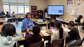Teacher works with elementary school students