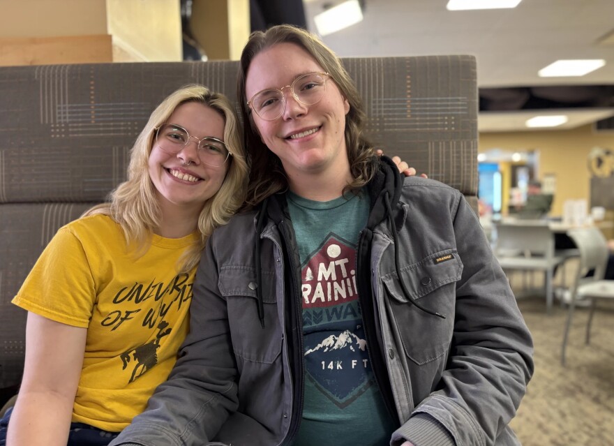 Miriam Harris and Aidan Freeman sit in a booth in the student union building at the University of Wyoming.