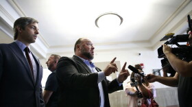 Alex Jones talks to media during a midday break during the trial at the Travis County Courthouse in Austin, Texas, Tuesday, July 26, 2022. An attorney for the parents of one of the children who were killed in the Sandy Hook Elementary School shooting told jurors that Jones repeatedly “lied and attacked the parents of murdered children” when he told his Infowars audience that the 2012 attack was a hoax. Attorney Mark Bankston said during his opening statement to determine damages against Jones that Jones created a “massive campaign of lies” and recruited “wild extremists from the fringes of the internet ... who were as cruel as Mr. Jones wanted them to be" to the victims' families. Jones later blasted the case, calling it a “show trial” and an assault on the First Amendment.