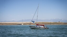 Sailboat on the Great Salt Lake with The Great Saltair in the distance, June 15, 2024. With Great Salt Lake’s sentinel landscape designation, it’s not just military installations that will see the benefits. Program administrators say it can also open the door to more conservation and recreational opportunities, like sailing.