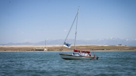 Sailboat on the Great Salt Lake with The Great Saltair in the distance, June 15, 2024. With Great Salt Lake’s sentinel landscape designation, it’s not just military installations that will see the benefits. Program administrators say it can also open the door to more conservation and recreational opportunities, like sailing.