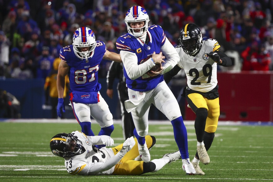 Buffalo Bills quarterback Josh Allen breaks free from Pittsburgh Steelers safety Damontae Kazee to carry the ball for a touchdown during the second quarter of an NFL playoff game Jan. 15 in Buffalo. The Bills won, and face the Kansas City Chiefs on Sunday.