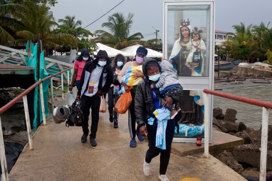 Haitian migrants in Necoclí, Colombia, walk toward boats that will take them to the town of Acandí, across the Gulf of Urabá. The boats can't keep up with the number of Haitians looking to travel from Colombia through the jungle to Panama to eventually reach the U.S.