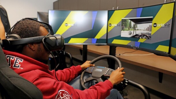 A South Carolina State University junior industrial engineering major test drives the driver cockpit simulator in SC State's new SMART Virtual Reality Lab.