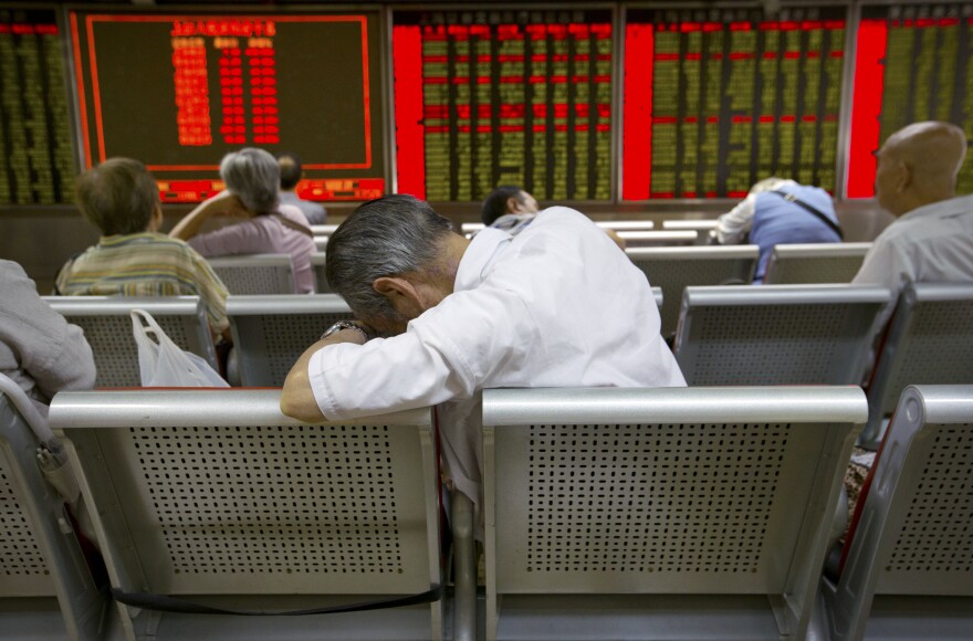 Chinese investors monitor stock prices at a brokerage house in Beijing on Tuesday.