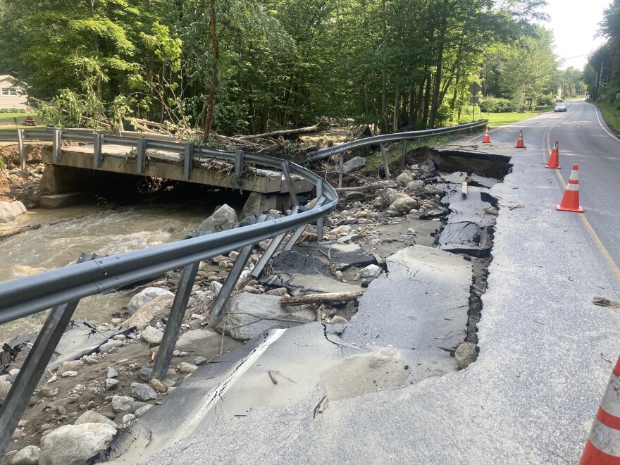 Chunks of asphalt and debris make a mess on the side of a road