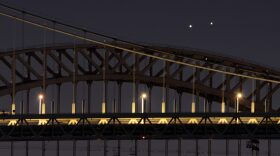 Venus (L) and Jupiter (R) rise together in a  rare conjunction over the Hell Gate (rear) and Robert F. Kennedy (front) Bridges in the early morning in New York. 