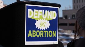 “Defund big abortion” appears on the podium from which a slate of leaders spoke on Jan. 28, 2026, at a March for Life rally in Topeka, Kansas.