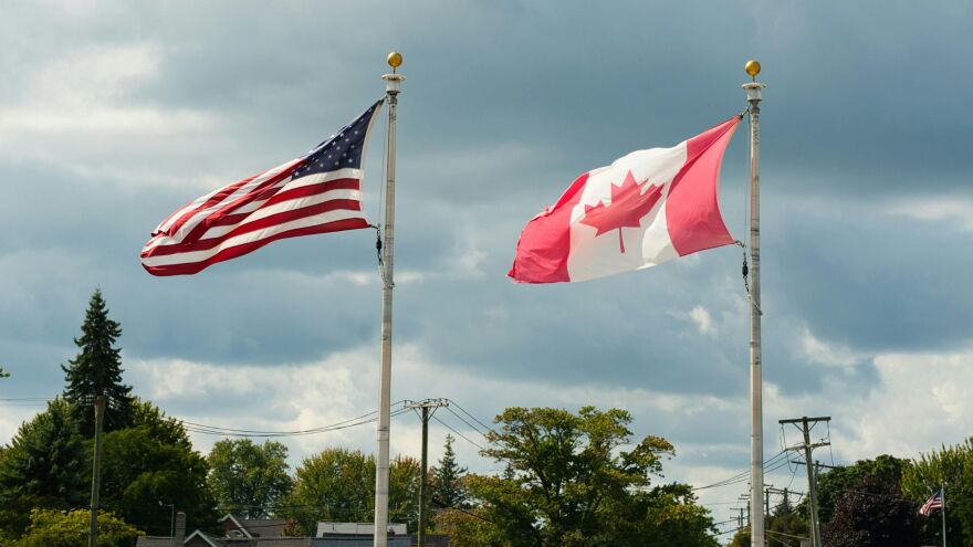 US and Canada flags flying side by side