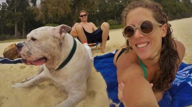 Mary Finley, Travis Sherman and Tonka at the beach. "I'm fearful of the world that we are making for ourselves," Travis said. "That's why I don't want to have children." (Courtesy Mary Finley)