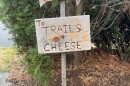 A sign in Grafton directing pedestrians to trails and cheese