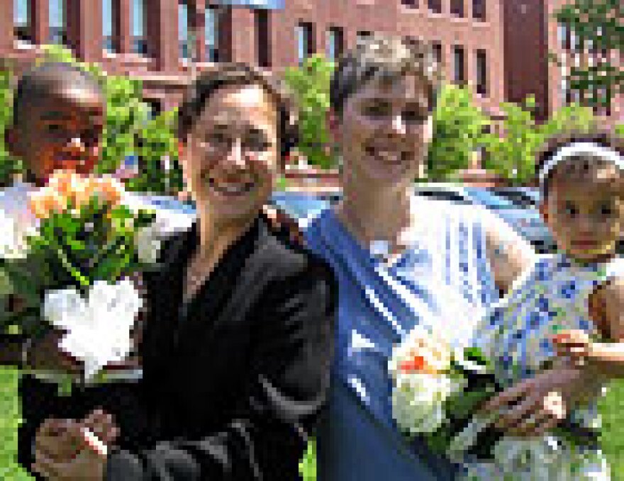 Stacy, left, and Jessie Harris, with their children, four-year-old Zion and one-year-old Torin. The couple drove to Massachusetts to marry on Thursday. Out-of-state couples may soon be prevented from obtaining wedding licences in Massachusetts.