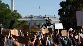 Demonstrators hold up placards protest outside of the White House, over the death of George Floyd in Washington D.C. on June 1, 2020. (JOSE LUIS MAGANA/AFP via Getty Images)