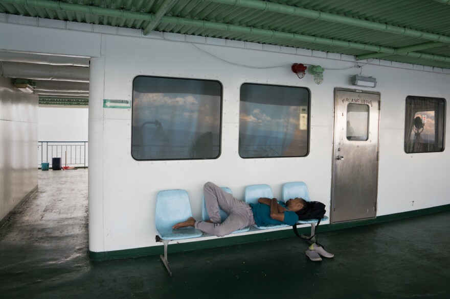 The hum of motors and rocking of the ferry lull passengers to sleep, despite the plastic benches.