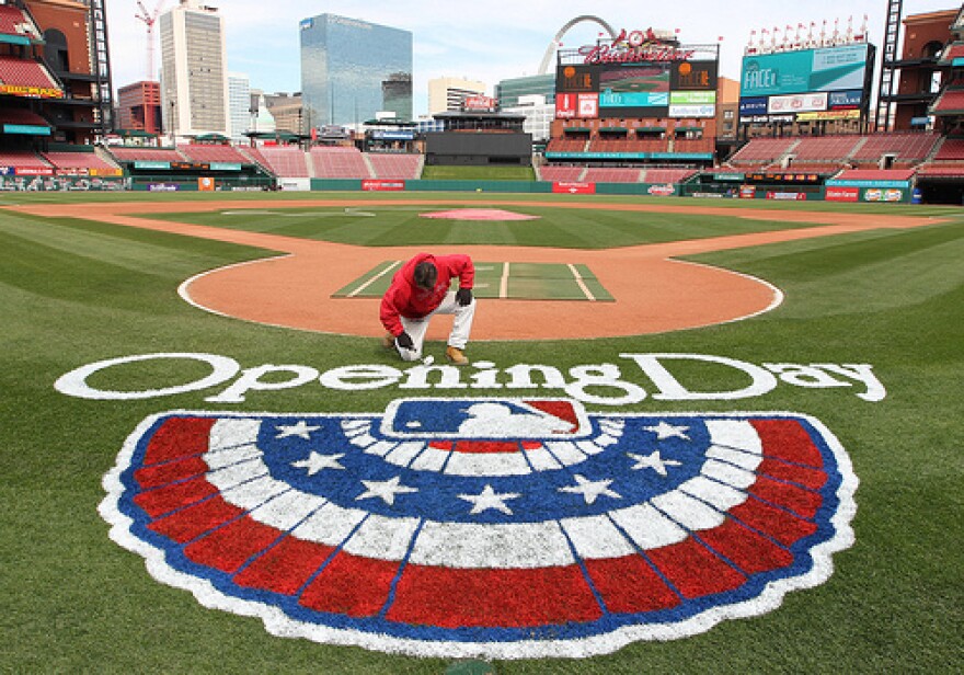 Billy Martin, the head painter at Busch Stadium, touches up the Opening Day logo. About 1500 meters in the city will be free on Opening Day from 10am until 30 minutes after the game ends.