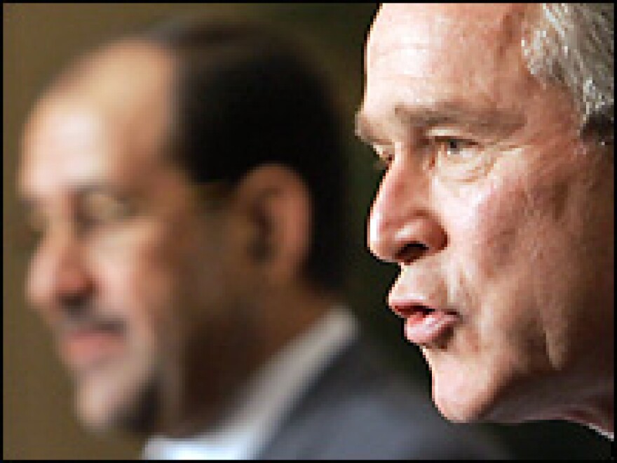 U.S. President George W. Bush speaks during a news conference with Iraqi Prime Minister Nouri Maliki (far left) at the Four Seasons Hotel in Amman, Jordan, on Thursday.