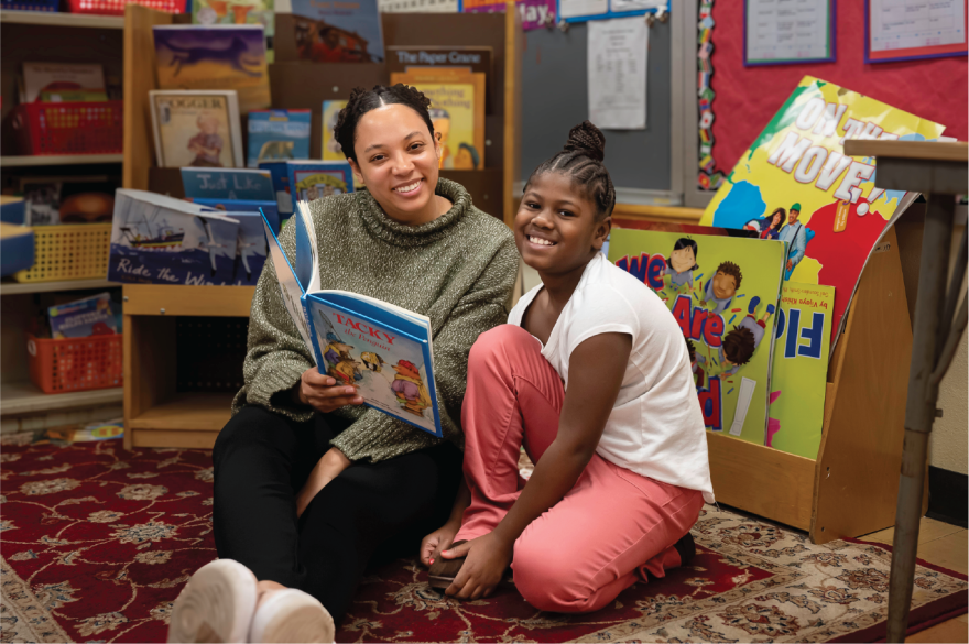 A teacher teaching a student to read