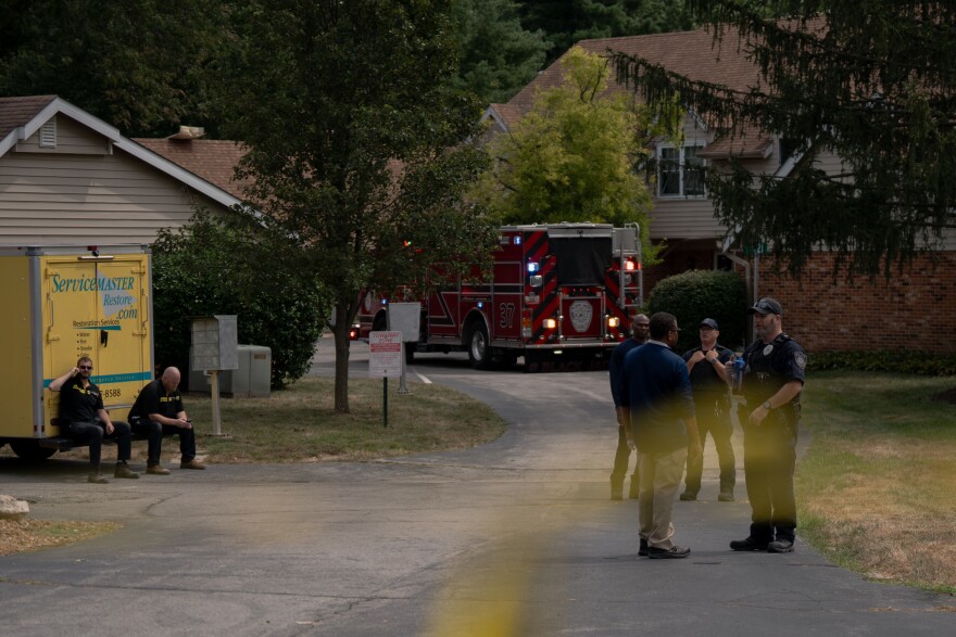 St. Louis County forest responders and cleanup crews gather outside of a row of condominiums severely damaged after homes blew up nearby on Monday, Aug. 25, 2025, near Black Jack, Mo.