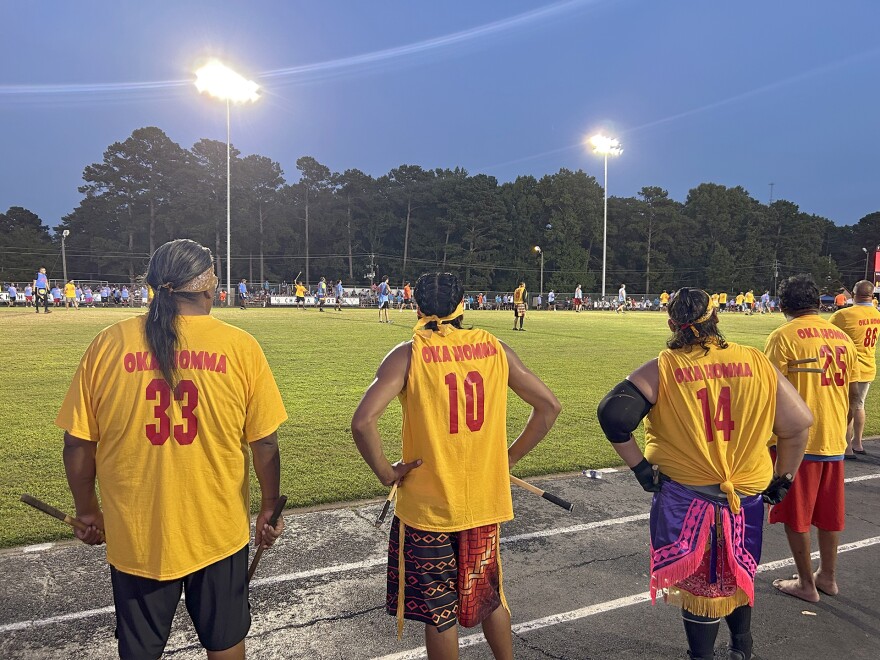 Members of Oka Homa's stickball team stand on the sidelines during the championship game of the 35 and Older division of the World Series of Stickball in Choctaw, Mississippi, on July 18, 2026.
