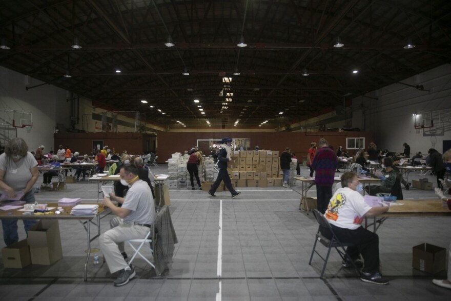 Dozens of volunteers extract ballots at the sports complex in Martinez on Oct. 31, 2020. By Halloween, Contra Costa County had already received more ballots than the total number in the March primary.