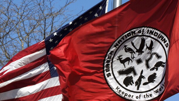 FILE - A Seneca Nation of Indians flag waves alongside an American flag during a news conference outside the Tribal Council building in Irving, N.Y., on April 19, 2007.