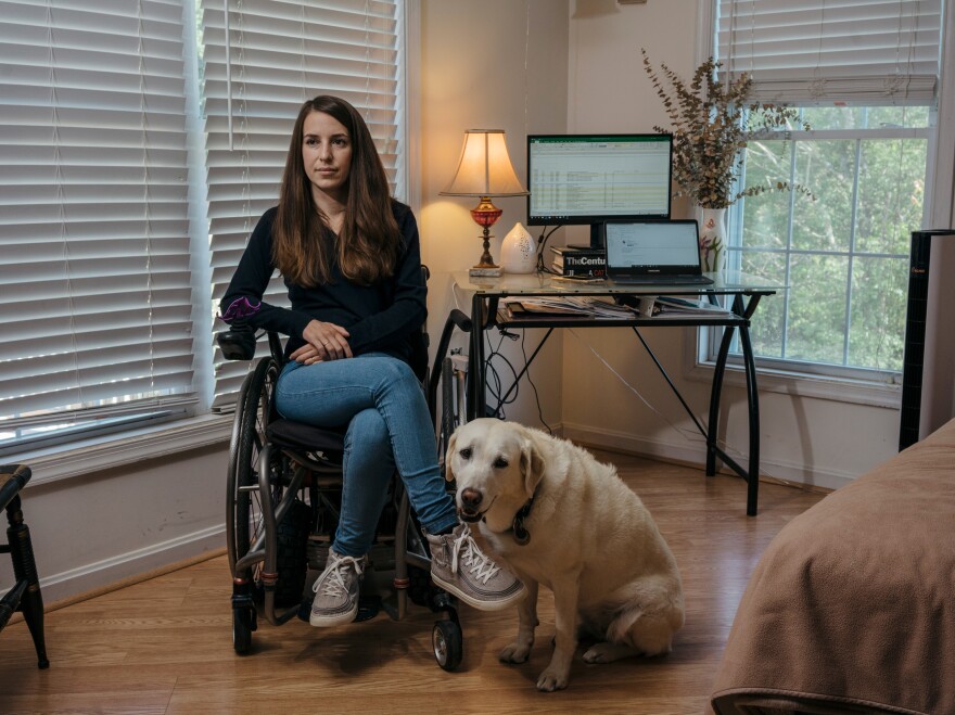 Izzie with her service dog, Zandra. Spinergy welcomed Zandra, who is able to retrieve things when Izzie drops them.