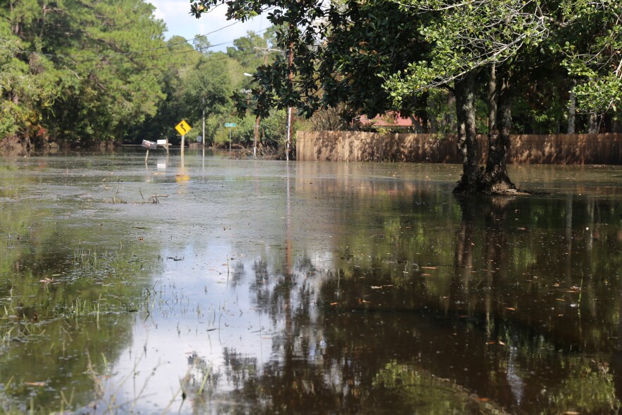  FILE - Flooded streets in Sherwood neighborhood east of downtown in Conway in October, 2015.